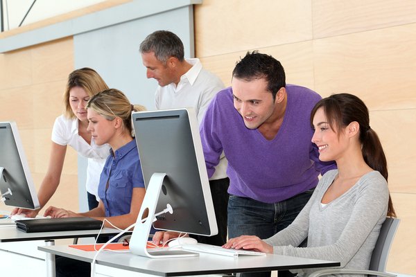 Group of students working at desktop computers.