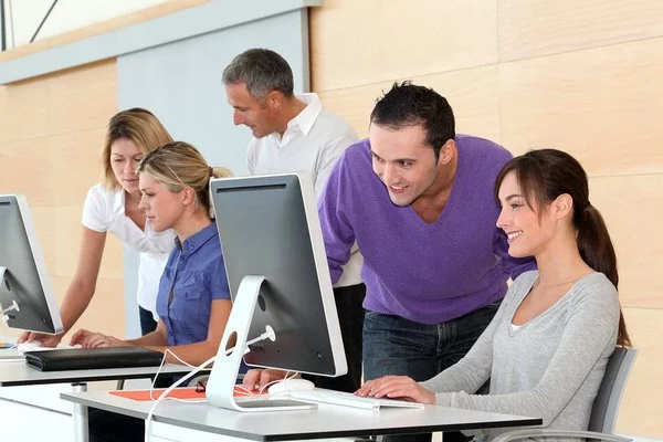 Group of students working at desktop computers.