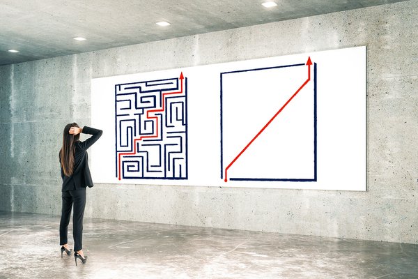 Woman looking at a wall painted of a maze.