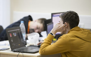 Computer workers falling asleep from working so hard.