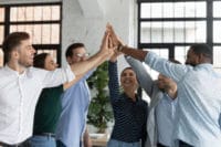 Group standing in a circle touching hands Solicit Employee Ideas