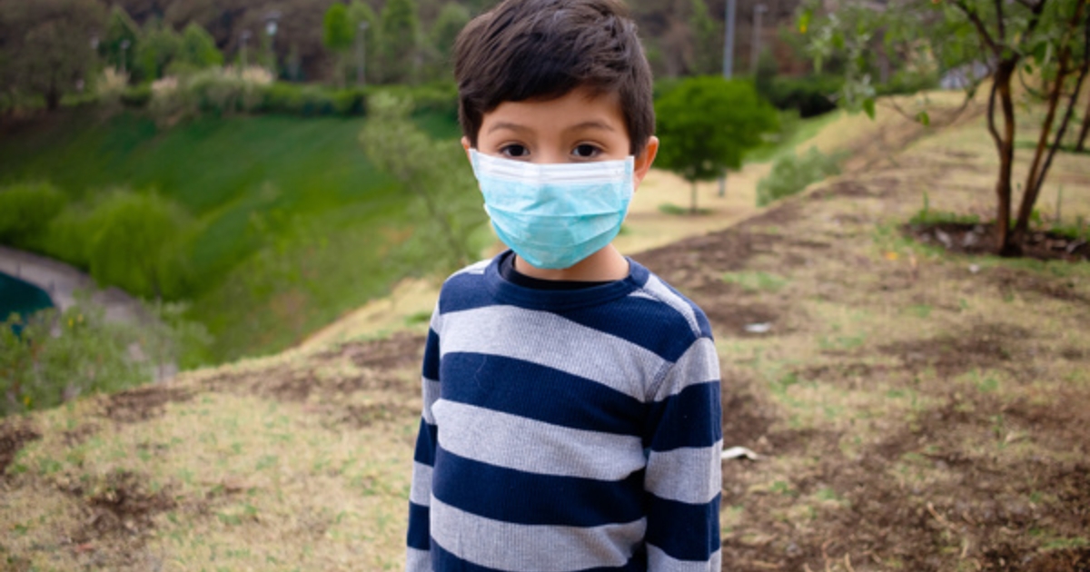 child wearing a protective face mask