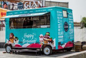 Picture of a food truck with the words "Happy Begining" signwritten on it.